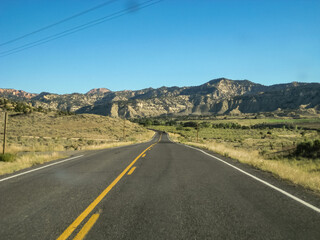 A long road with a yellow line down the middle