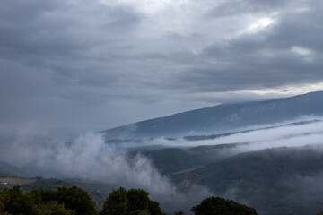 Dramatic mountain peaks during winter low cloud coverage, in the mountainous region of Kissavos, near Larissa town, in central Greece, GREECE, EUROPE.