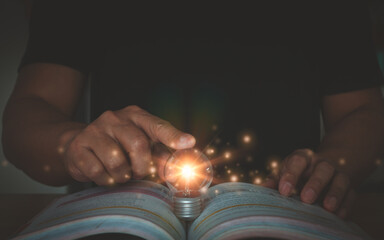 Self learning or education knowledge and business studying concept. Person hand touch glowing light...