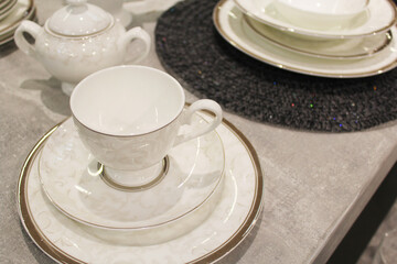 empty cup with saucers and white plates on the table