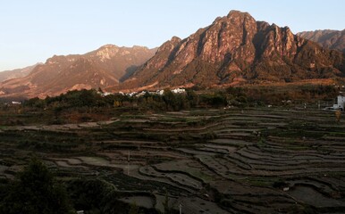 Harmony of Nature: Terraced Farmland and Towering Peaks in Perfect Balance