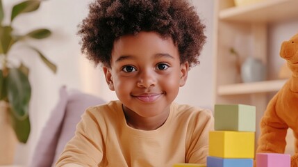 Fototapeta premium Portrait of a cheerful preschool child playing with colorful building blocks in a cozy home environment