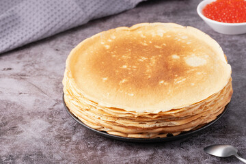 Freshly baked pancakes with red caviar