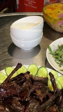 white heron roasted cuisine of the Sundanese people of Western Java, and Banten, Indonesia. Pictured here,fried chicken, Sambal, karedok or vegetable salad, fried tempeh, satay and fried fish.