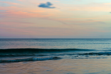 Fototapeta premium Evening ocean scene with gentle waves and a serene horizon.