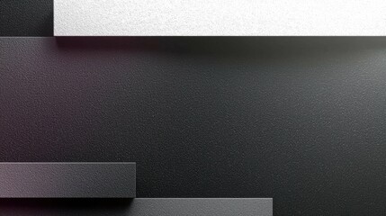A close-up view of gray textured surfaces with layered rectangular shapes against a dark background, showcasing a modern and elegant design.
