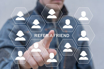 Person using virtual touchscreen push on text: REFER A FRIEND. Referral marketing or affiliate...
