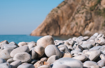 A rocky beach with a large rock in the middle