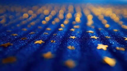 Rows of tiny gold stars creating a grid over a bright blue bokeh background