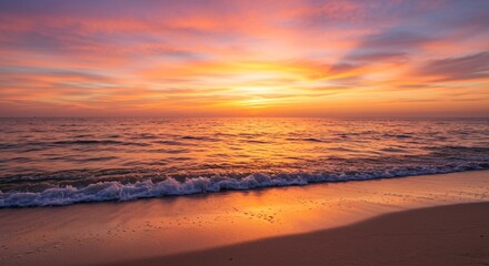 A tranquil beach at sunset with waves that sparkle as they crash
