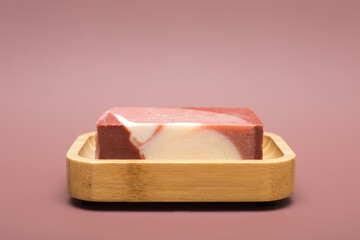  Natural multicolored handmade solid soap on a bamboo soap dish on a background of mocha mousse. Natural and eco-friendly handmade cosmetics. Natural spa products and bathroom decor. Color 2025