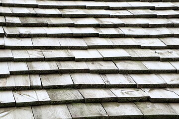 A CloseUp View of Weathered Wooden Shingle Roof Tiles Showcasing Their Rich Texture and History