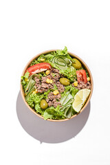 salad with tuna, tomatoes, cucumber and olives in container