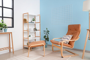 Comfortable armchair and shelving unit in living room