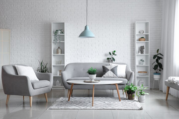 Comfortable armchair, sofa and table in living room