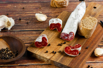 Fototapeta premium Marble cutting board with sliced salami on it