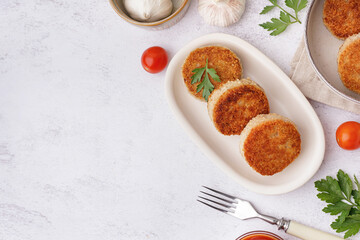 Plate of tasty meat cutlets on white background