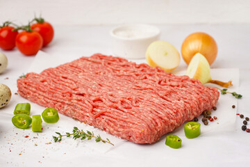 Fresh minced meat with spices on white background