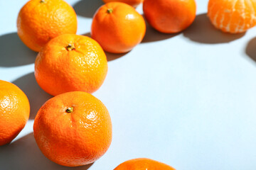 Many sweet mandarins on blue background