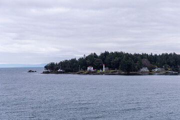 Scenic Lighthouse and Island Landscape on a Cloudy Day in British Columbia