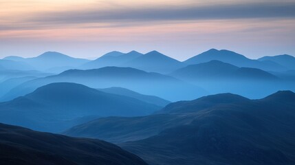 Fototapeta premium Serene blue mountain range at sunrise.