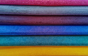 Colorful background, Pile of colorful fabrics. Full frame shot of multi-colored fabric background