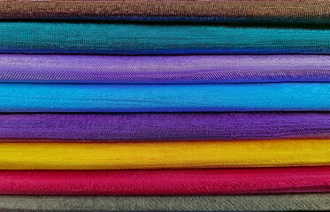 Colorful background, Pile of colorful fabrics. Full frame shot of multi-colored fabric background