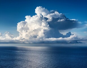 massive cumulus clouds over a calm ocean surface