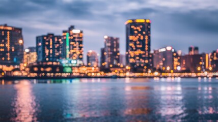 Obraz premium A stunning city skyline at twilight with shimmering lights reflecting on the water, creating a serene and captivating urban scene.