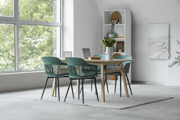 Interior of dining room with table and shelf unit