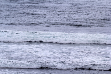 Stretch of ocean with waves crashing against the shore