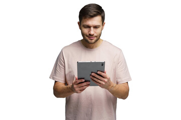 Fototapeta na wymiar Man focused on tablet screen while standing indoors in casual attire and light environment
