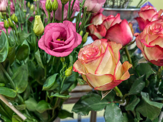 bright flower bouquet arrangement with rose flower head, yellow with red border petal, sales display