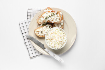 Bowl with fresh cottage cheese and slices of bread on white background