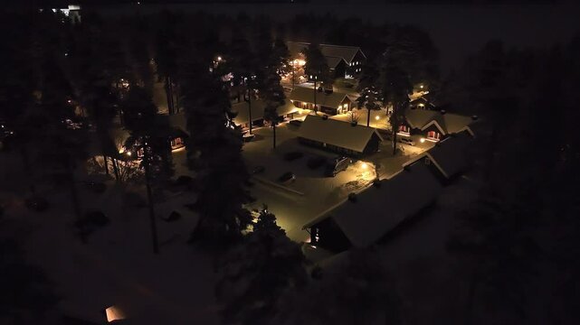 Aerial view of a illuminated Carelian Village, winter evening in Kainuu, Finland