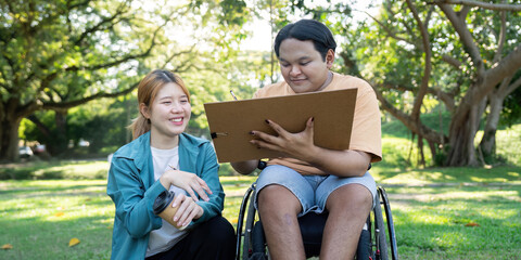 Disabled artist happily drawing with guidance from instructor in a serene outdoor park setting