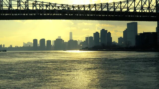 Bright sunset under the queensbridge looking at the freedom tower and NY skyline