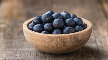 Bowl overflowing with ripe and juicy bilberries captured in natural light