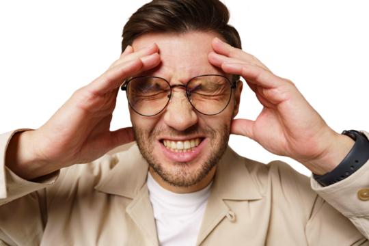 Man experiencing stress with hands on his head against a plain background in a close-up view