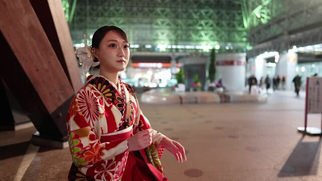 Young women in their 20s wear traditional Hakama (kimono) in Japan, known for the graduation ceremony. She is at the famous Kanazawa station in Ishikawa Prefecture.