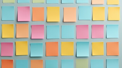 A vibrant array of colorful sticky notes arranged neatly on a wall, showcasing various pastel shades that inspire creativity and organization.