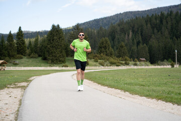 Runner In Green Shirt Jogging Outdoors