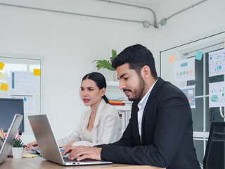 Business team woman and man asian group meeting sitting on desk looking talk think creative idea computer on table ready happy working new project job online product sale marketing in office company.