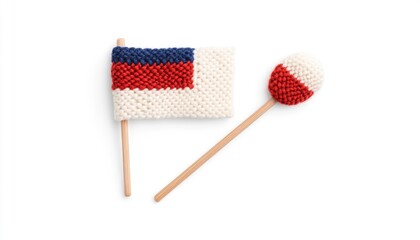 Handcrafted miniature Russian flag and round flagpole decoration on a plain background, showcasing creativity