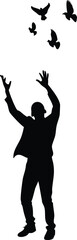 Silhouette of the guy lets go of the dove into the sky