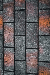 Stone bricks with rough texture, geometric design, and earthy tones of gray and orange.