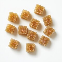 Scattered light brown sugar cubes on white background.