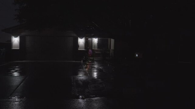 Night Home with Rain and Kid Walking out with Umbrella