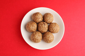 Sesame seed jaggery ball or til ke laddo and tilgul or til gul laddu served in bowl for Makar Sankranti Festival in India