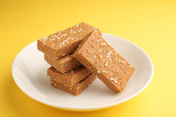 Sesame seed jaggery barfi or til ke gul   barfi and tilgul or til gul barfi 
 served in bowl for Makar Sankranti Festival in India